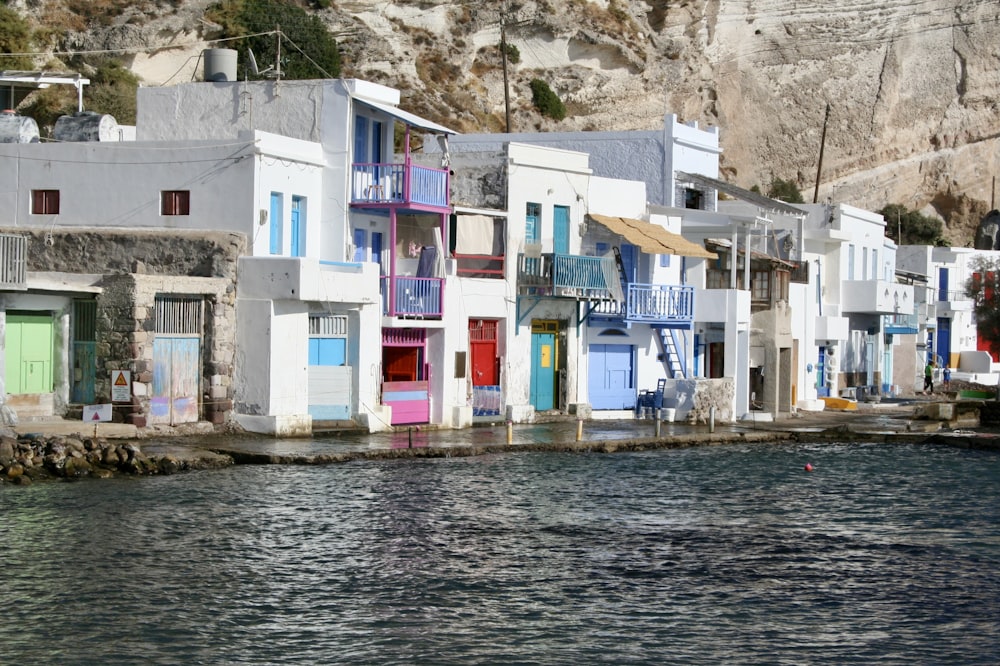 white concrete building beside body of water during daytime