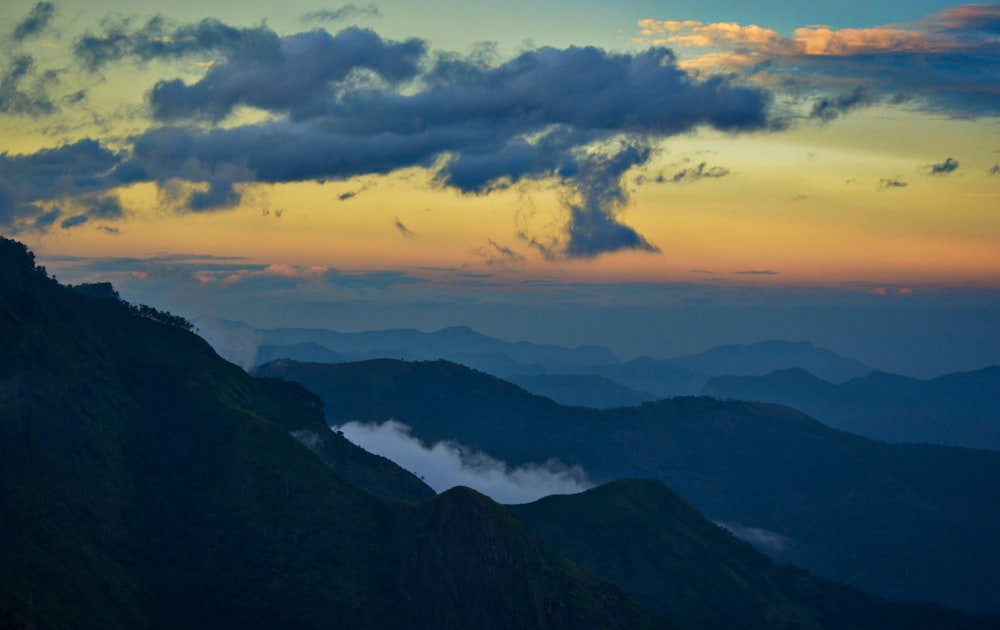 mountains under white clouds during daytime