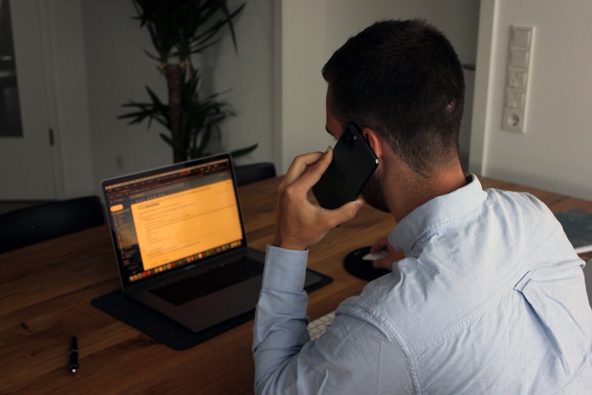 A professional holding a phone mid-conversation, the kind of real call this toolkit is built to capture