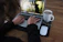 person using macbook pro on brown wooden table