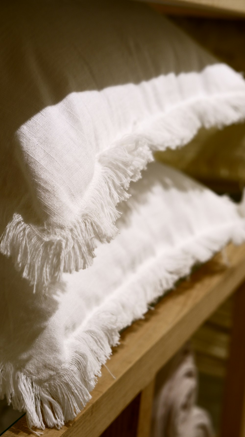 white textile on brown wooden table