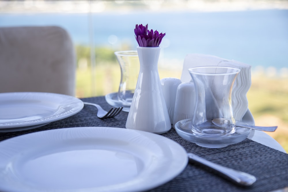 white ceramic plate and clear glass pitcher on table