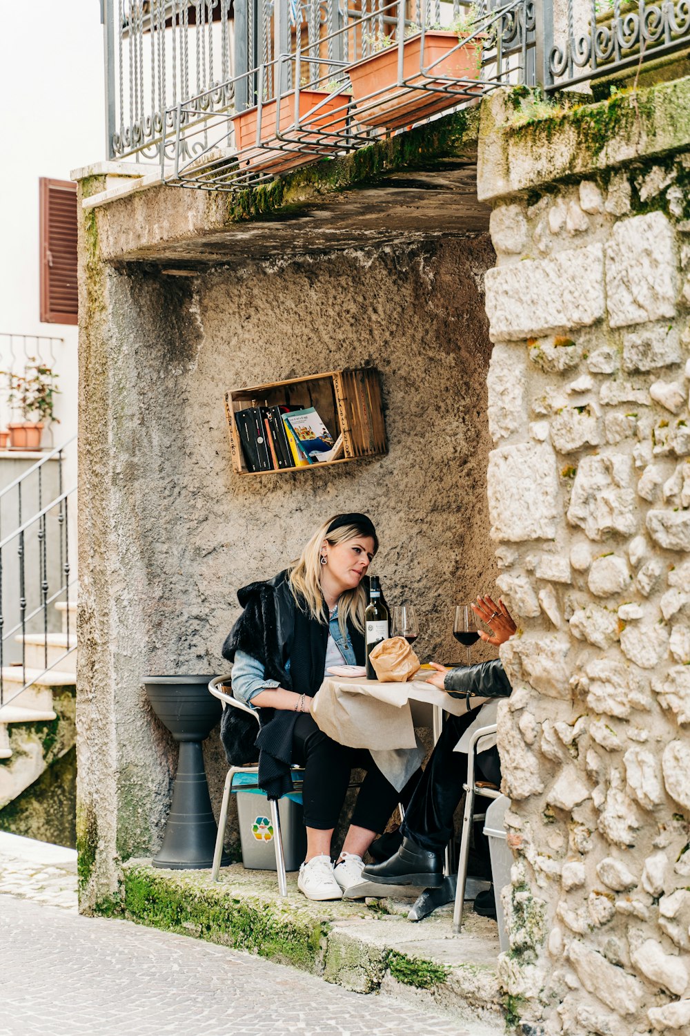 woman in black coat sitting on chair