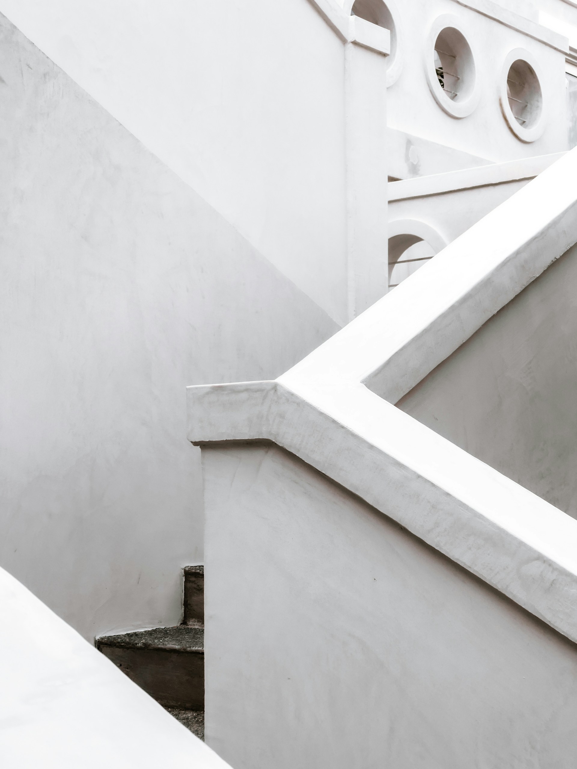 white concrete staircase with white concrete wall
