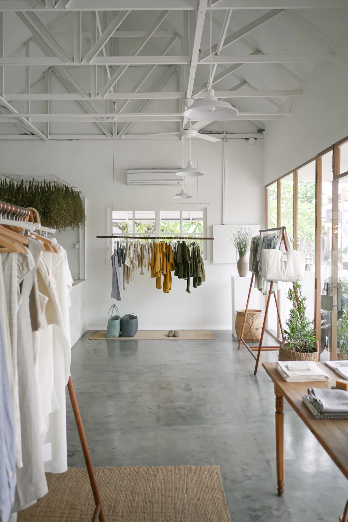 A bright boutique interior with garments hanging on open rails