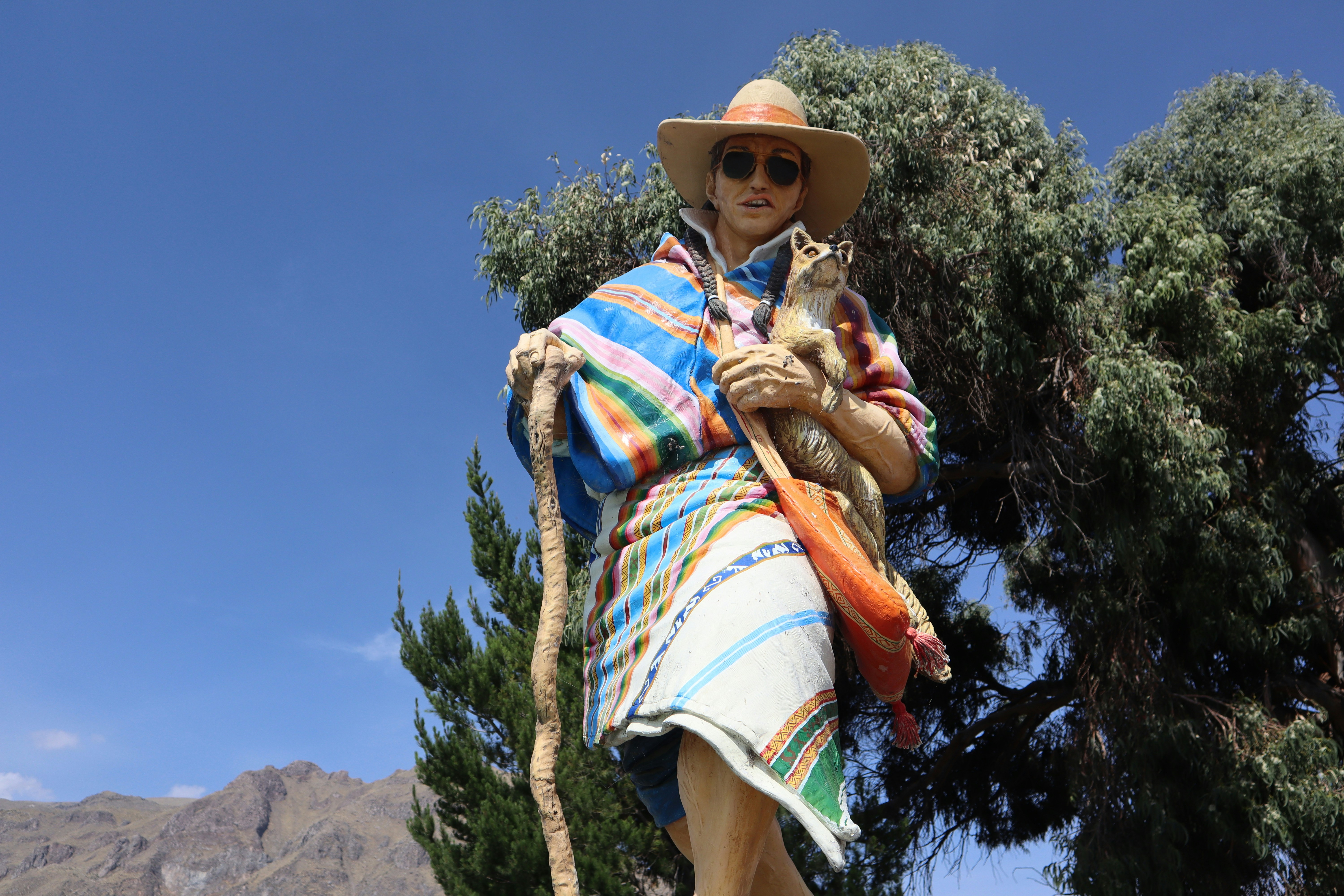 woman in brown sun hat carrying baby