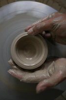 Ravi Guntaka carefully shaping the clay fridge during the early prototype phase.
