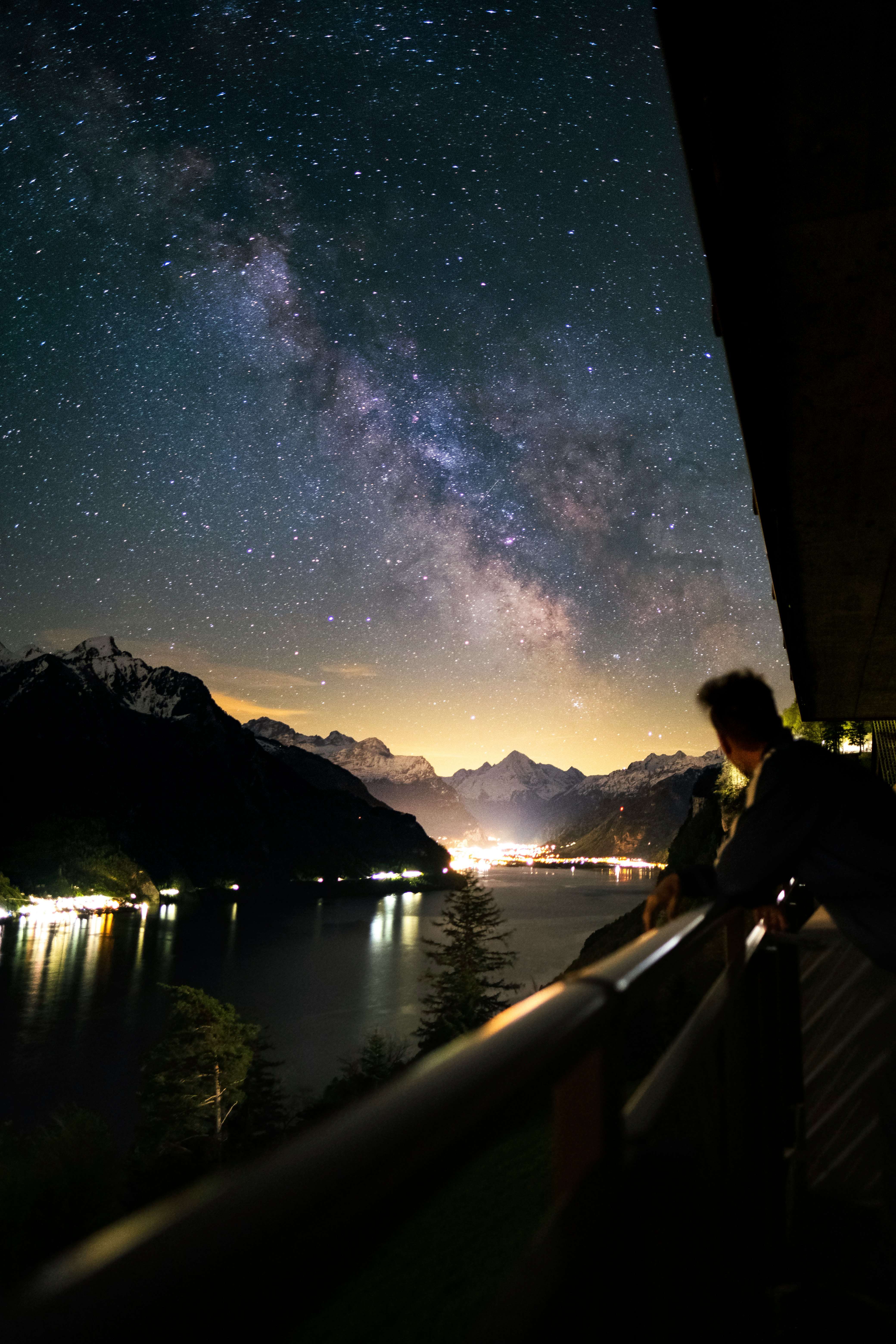 man in black suit standing on bridge during night time