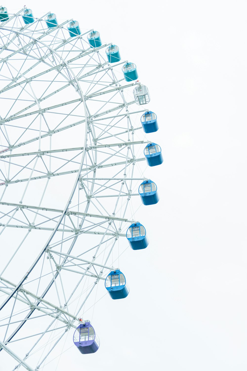 white ferris wheel under white sky during daytime