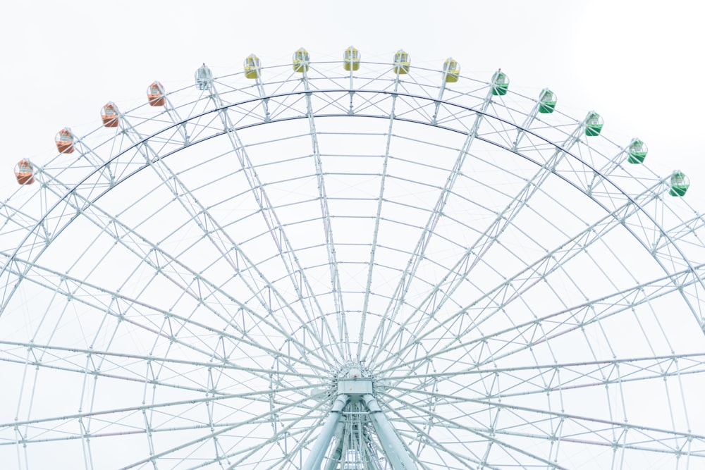 white ferris wheel under white sky during daytime