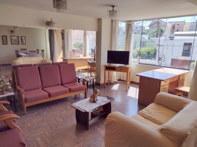 A cozy, well-lit apartment living room ready for rent in Hyderabad.