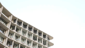 A sleek, modern architectural building with clean lines and a minimalist facade under soft natural light.