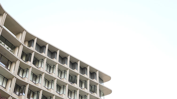 A sleek, modern architectural building with clean lines and a minimalist facade under soft natural light.