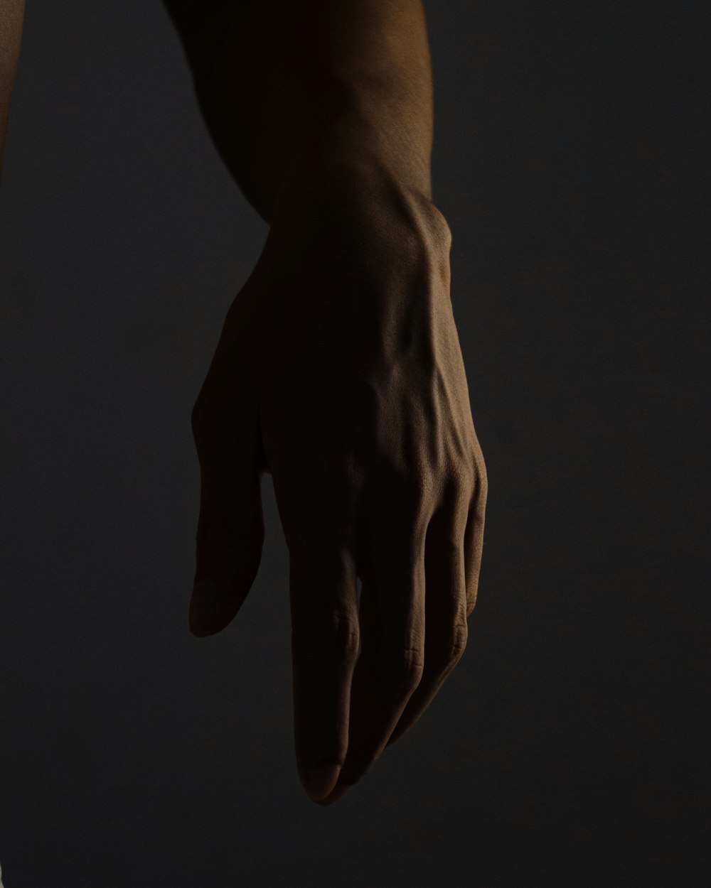 persons hand on black background