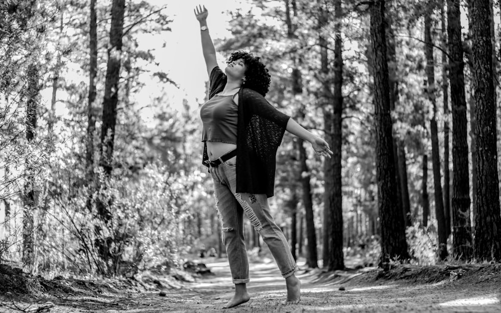 grayscale photo of woman in black long sleeve shirt and white pants