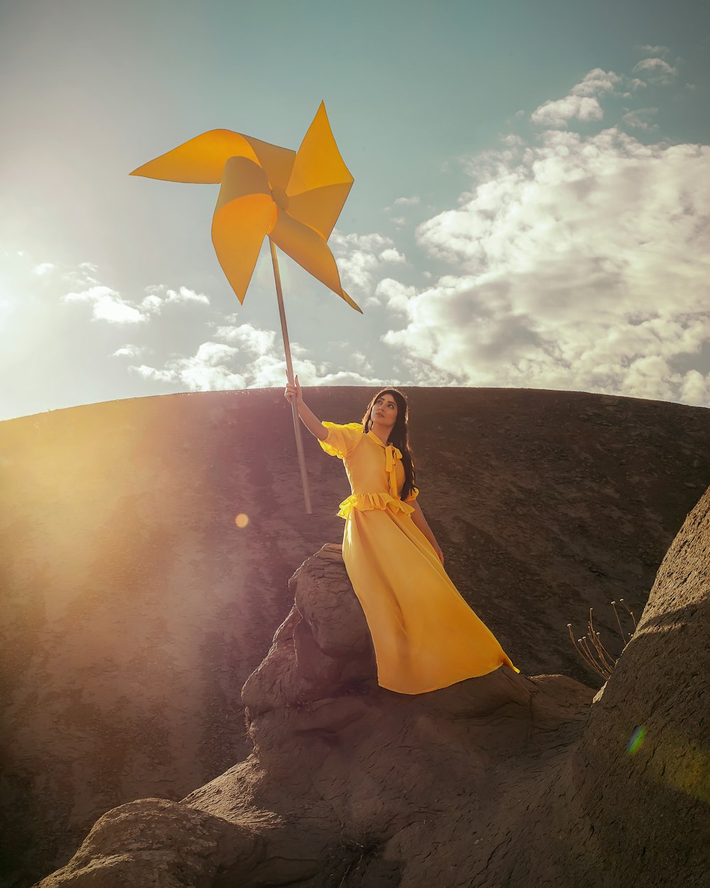 woman in yellow dress holding yellow umbrella