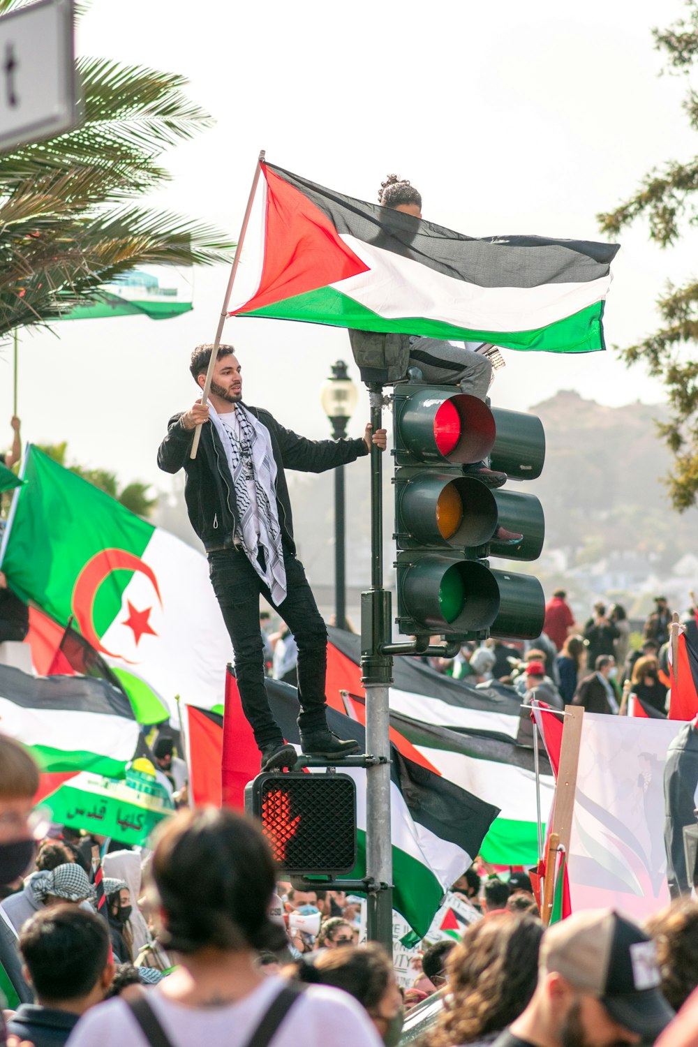 man in black leather jacket holding white flag