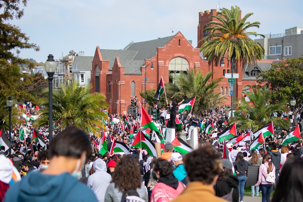 people gathering near brown concrete building during daytime