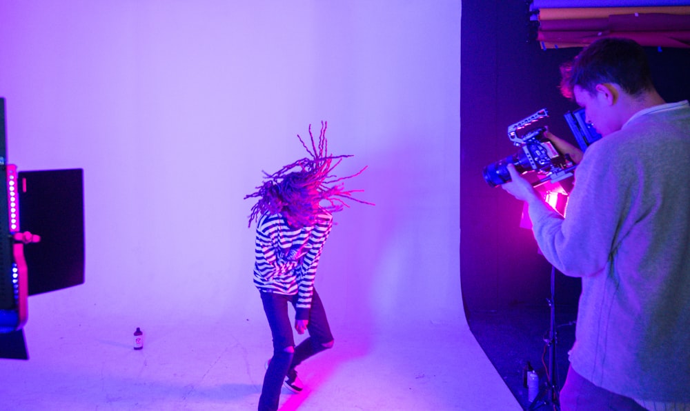 woman in black and white zebra print dress holding a white string lights