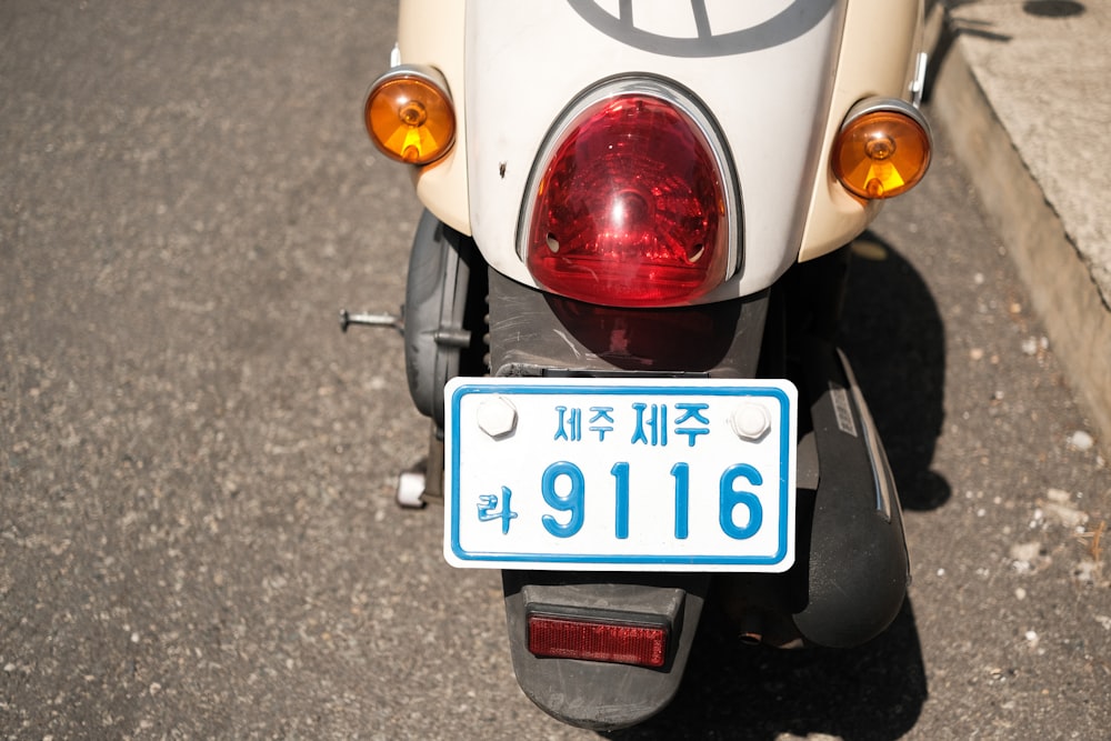 white and red motorcycle license plate