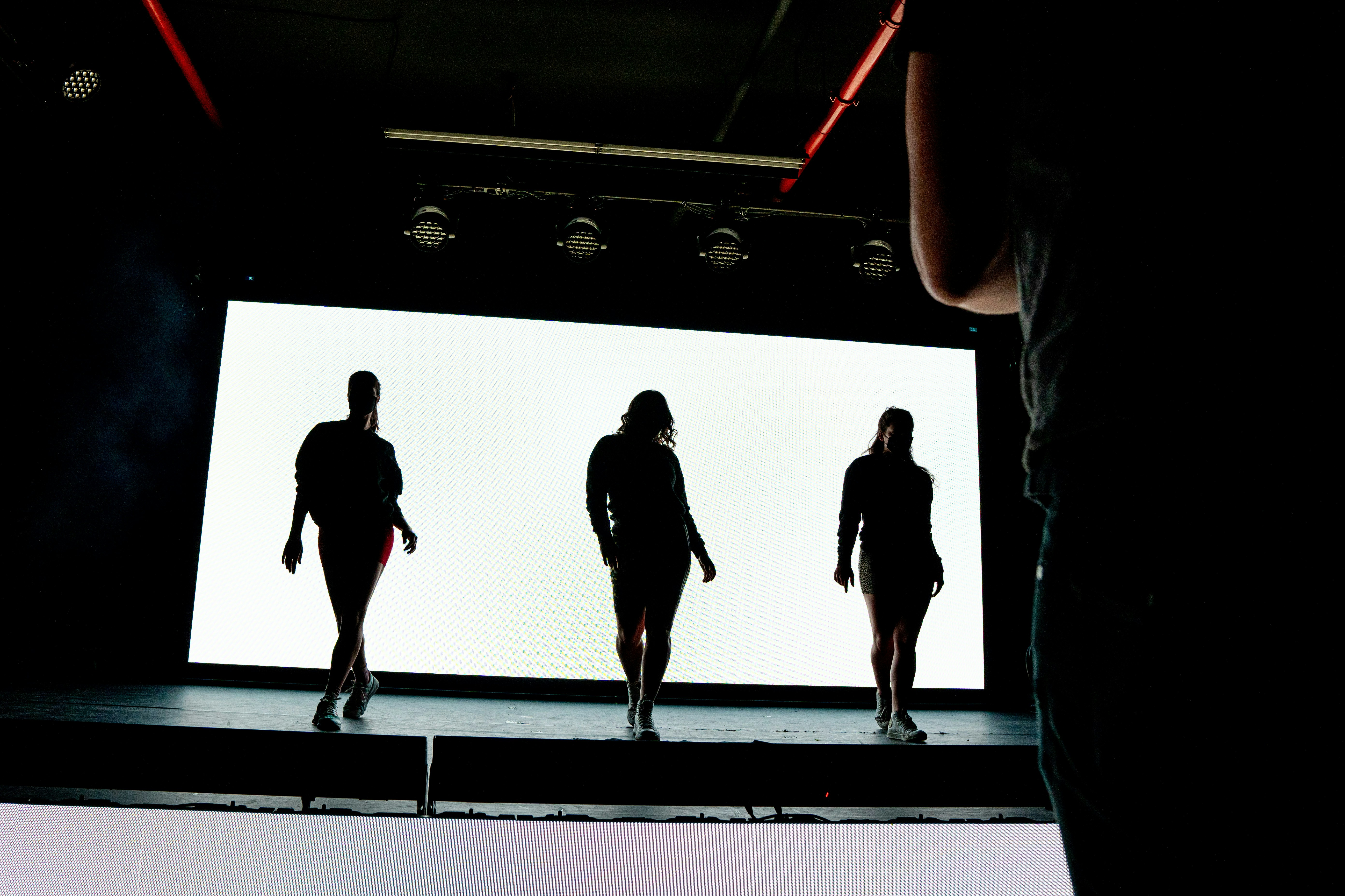 silhouette of people walking on stage
