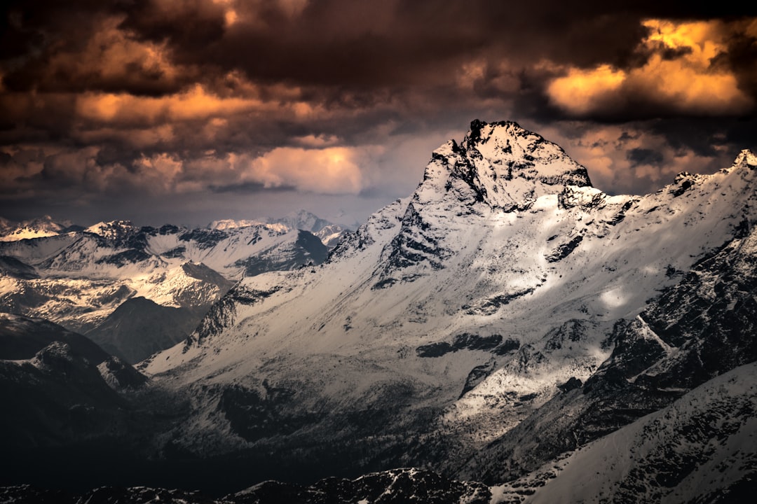 snow covered mountain under cloudy sky during daytime