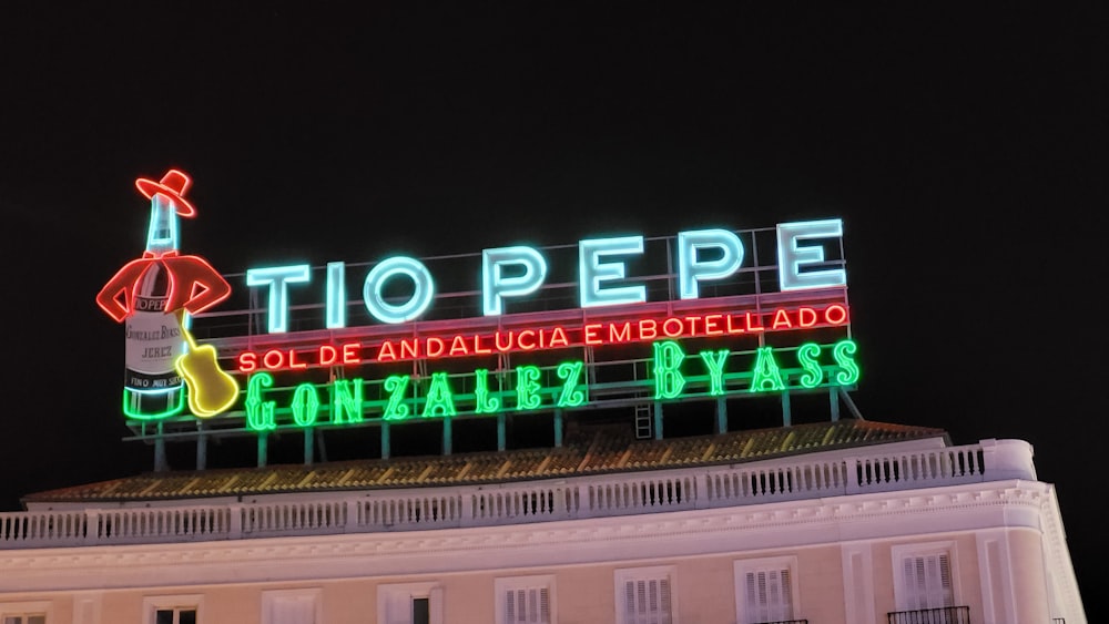 a large neon sign on top of a building