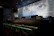 A stylish interior shot showing the dark, luxurious decor of the sushi restaurant.
