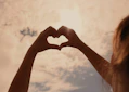 persons hand forming heart