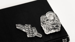 clear glass bottle on black table