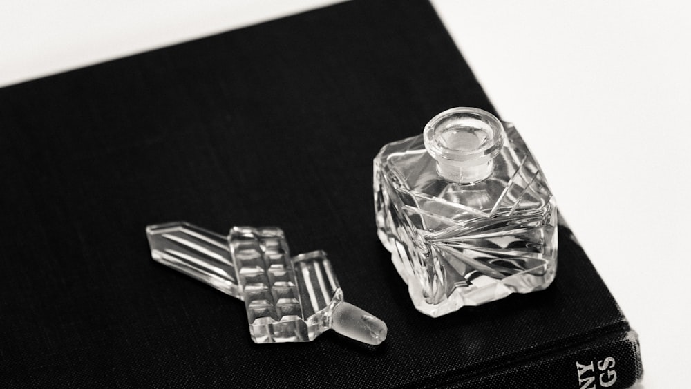 clear glass bottle on black table