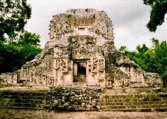 gray concrete building near green trees during daytime