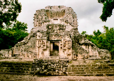gray concrete building near green trees during daytime