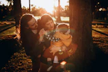A family enjoying a warm afternoon outdoors, bathed in soft yellow light.