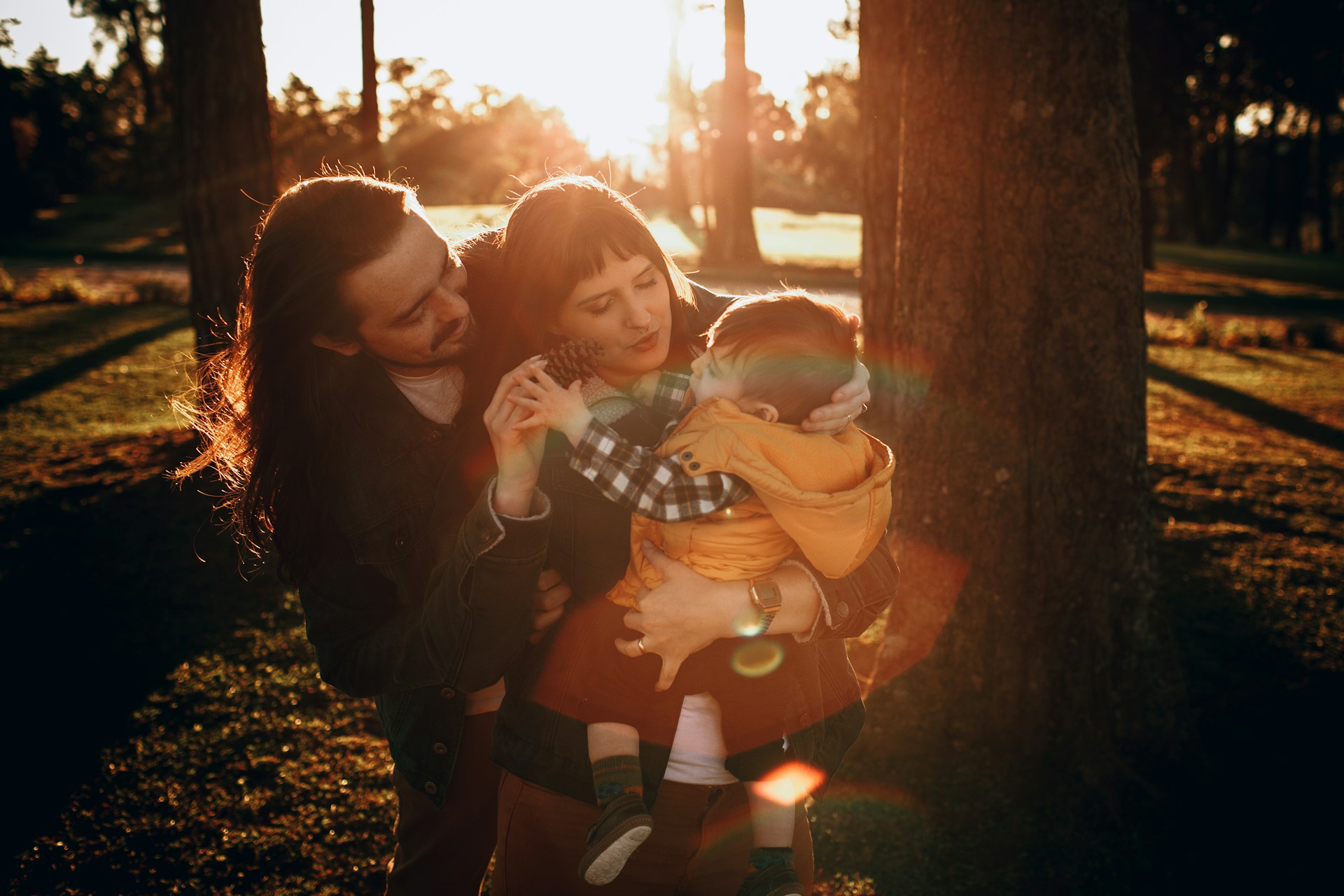 A serene and intimate family photoshoot in a natural park, emphasizing love and connection.