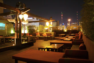Relaxing outdoor lounge area with comfortable seating and warm lighting at dusk.