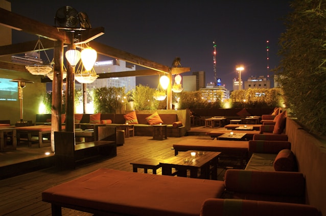 Evening view of the residence’s outdoor lounge area with ambient lighting and cozy seating.