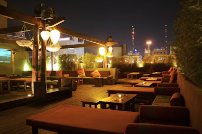 Cozy outdoor lounge area with elegant white furniture and subtle gold accents under soft evening light