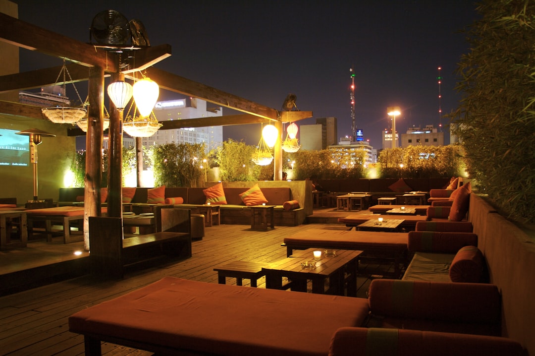 brown wooden table and chairs set, Rooftop restaurant bar