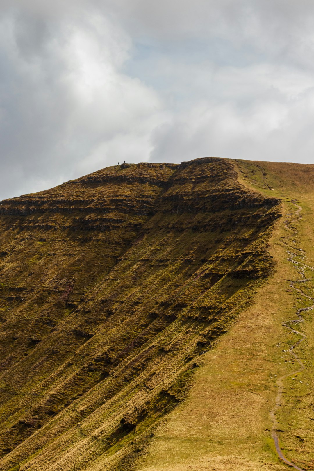 brown mountain under white clouds during daytime