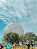 A panoramic view of Epcot’s iconic geodesic sphere under a bright afternoon sun.