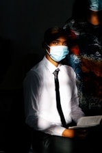 A doctor reading a medical book in a cozy, well-lit study.
