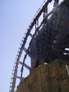 A Wangjia water wheel spinning actively in a shrimp farm pond.