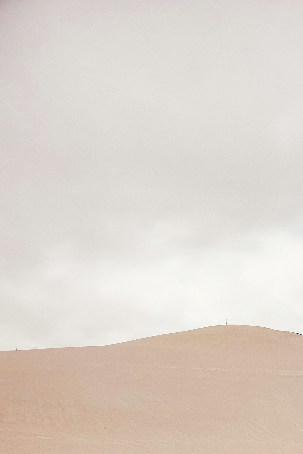 brown sand under white sky during daytime