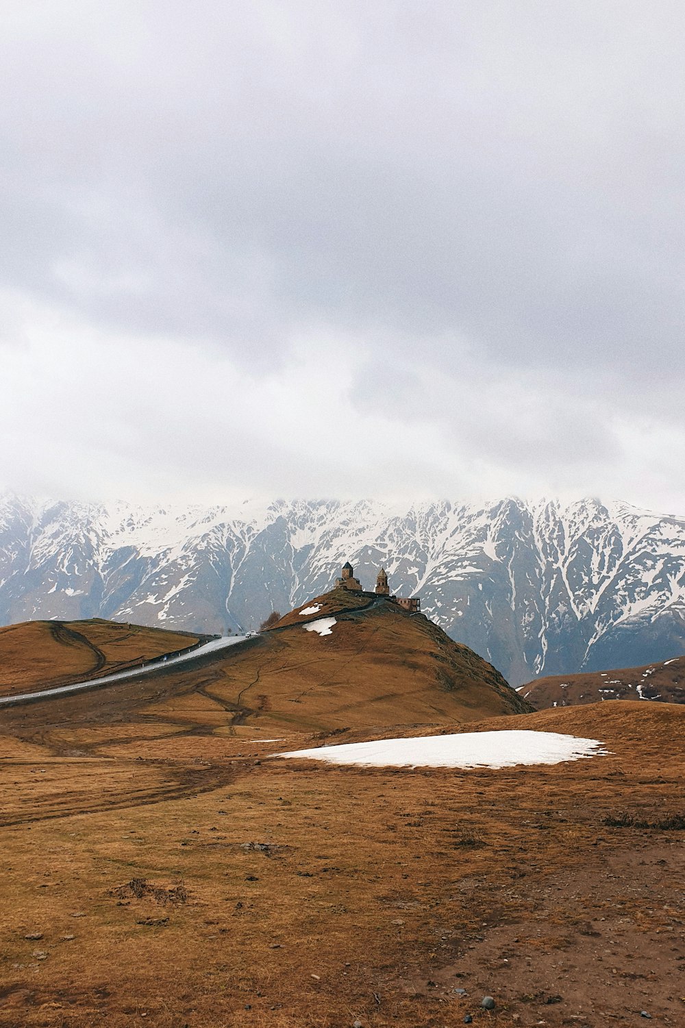 brown and white mountains under white sky during daytime