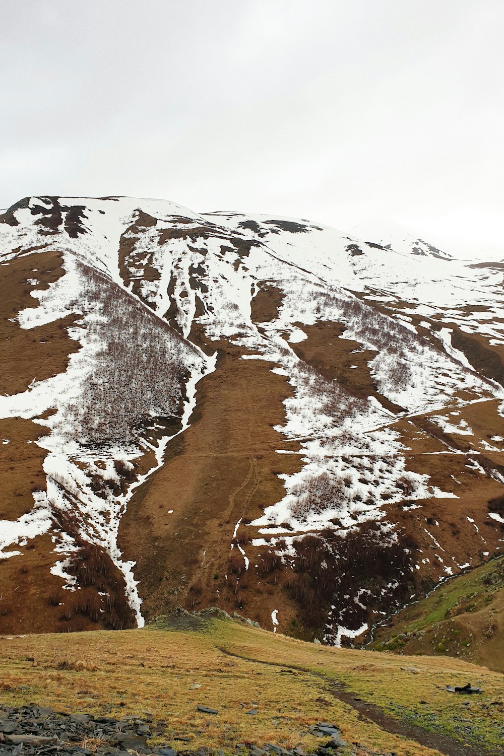 brown and white mountain under white sky during daytime