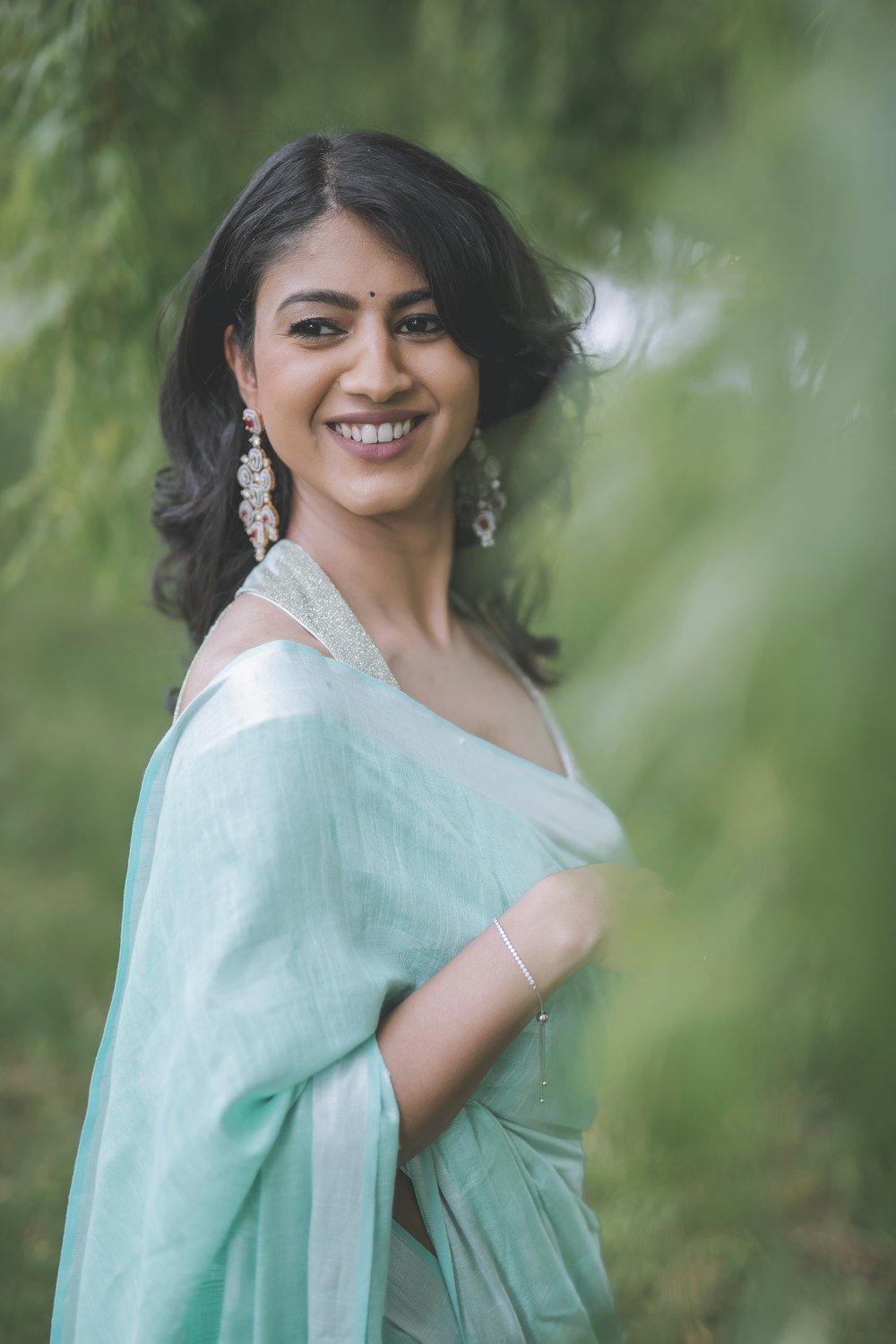 woman in white and blue dress smiling