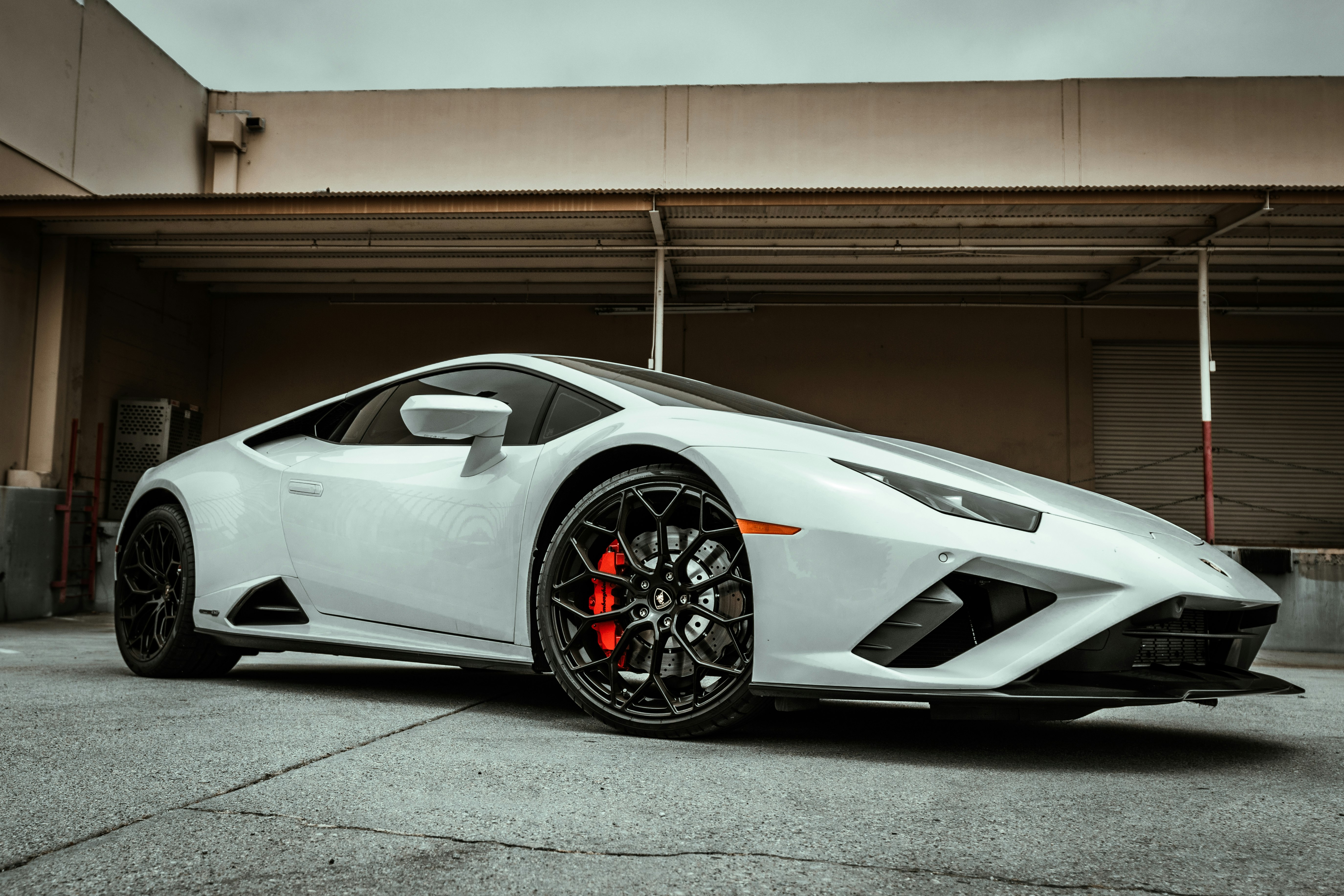 white lamborghini aventador parked in garage