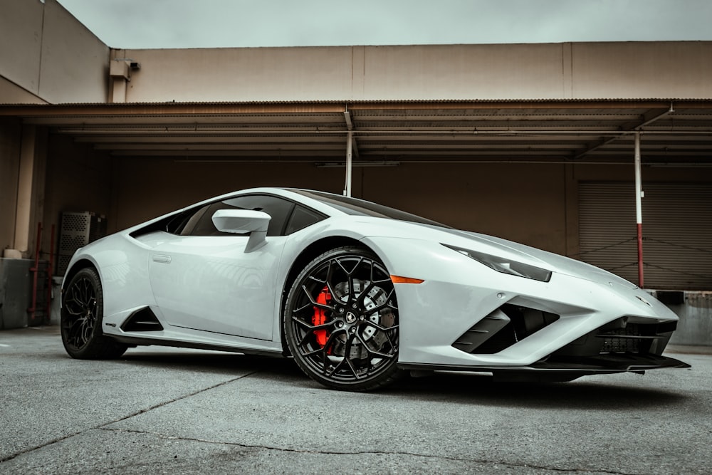 white lamborghini aventador parked in garage