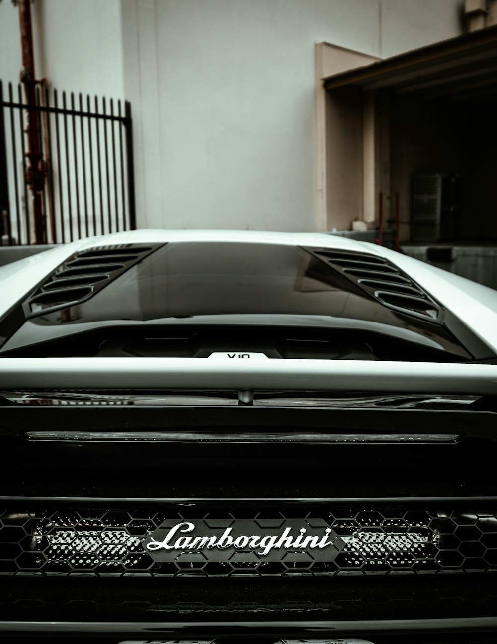 white and black porsche 911 parked in garage